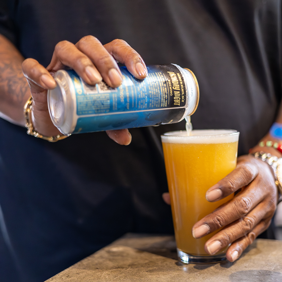 Killer Mike of Run The Jewels opening a can of his collaboration beer with Monday Night Brewing